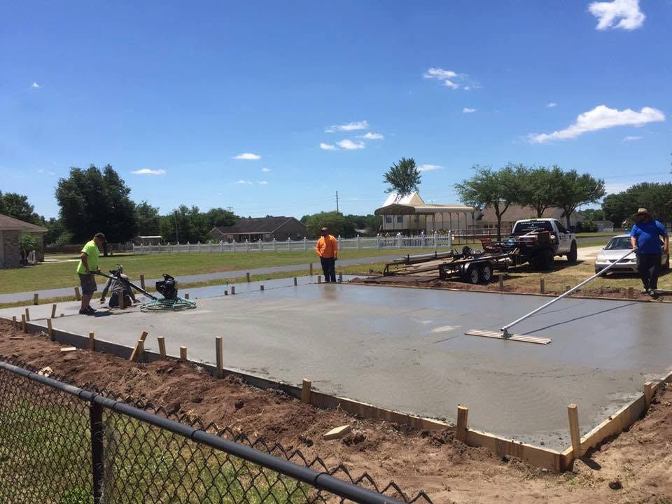 Crew screeding a fresh slab inside the forms