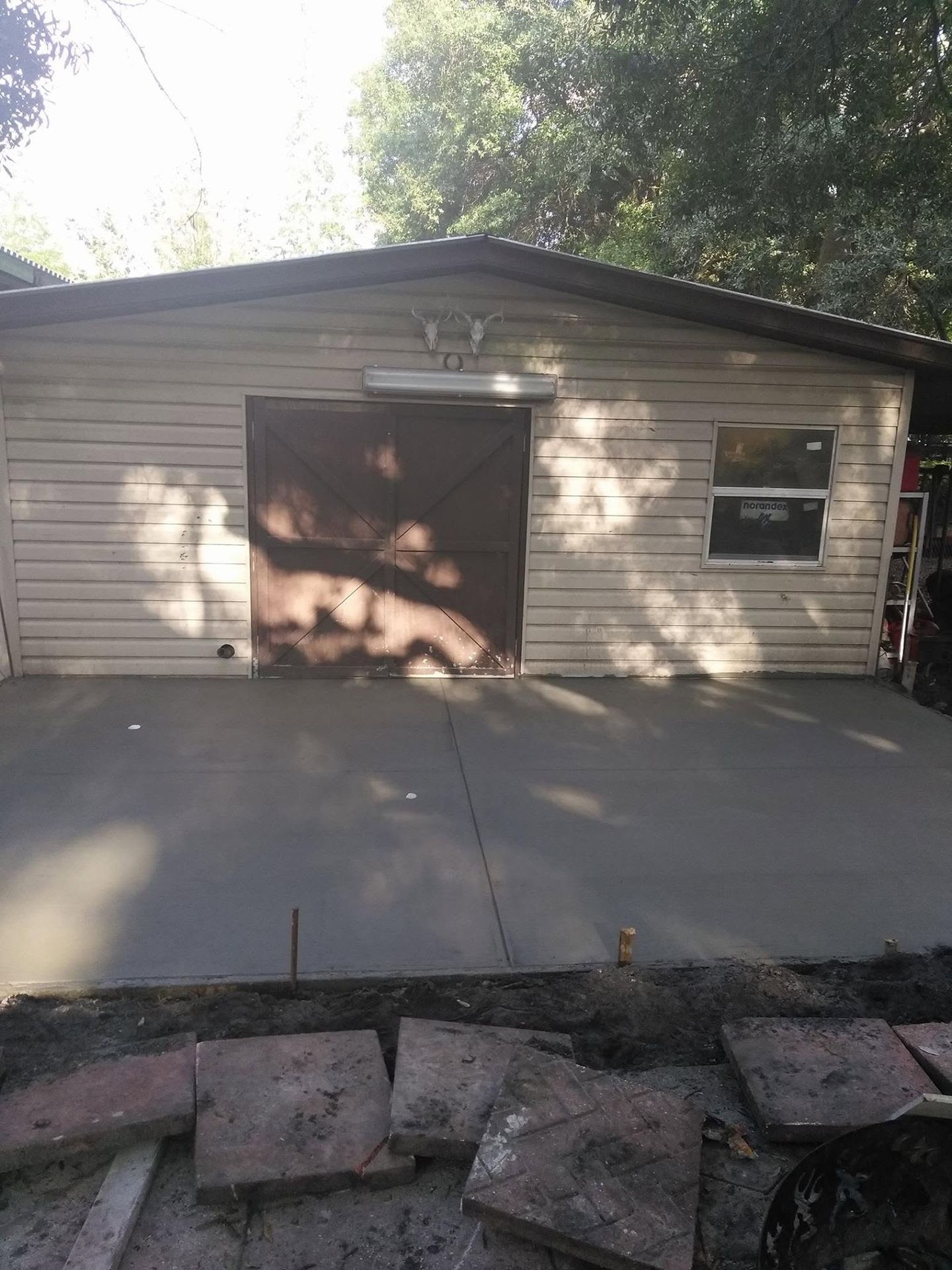 Concrete apron in front of a shed door