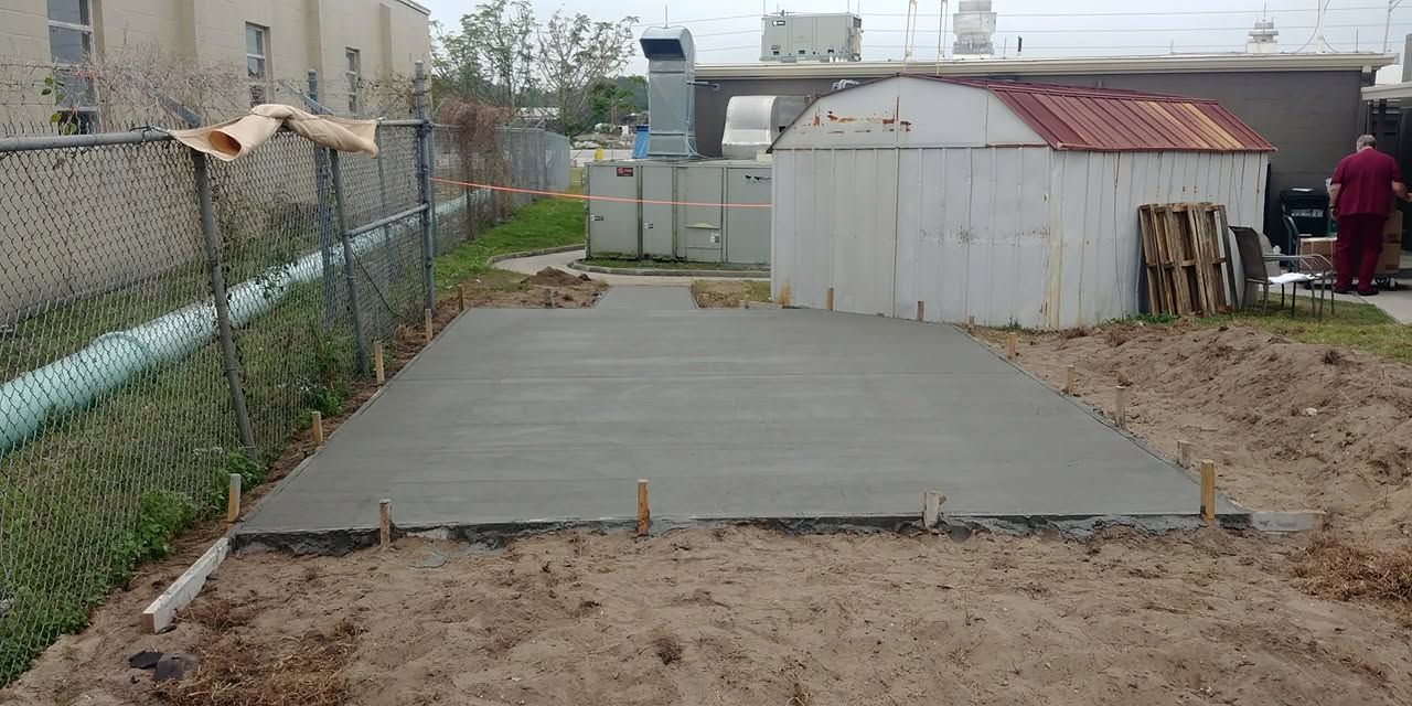 Shed pad poured along a fence line